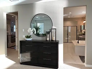 A built-in home office wrapped in cherry cabinetry, framed by an arched doorway.