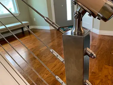 Stainless cable railing detail on an open staircase, a modern alternative to traditional balusters.